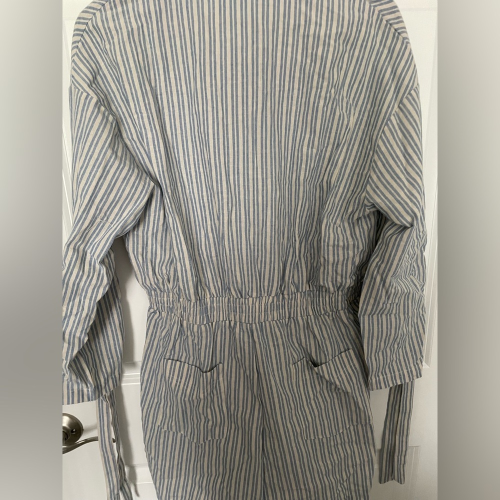 Three quarter sleeve blue and white stripe button down romper.